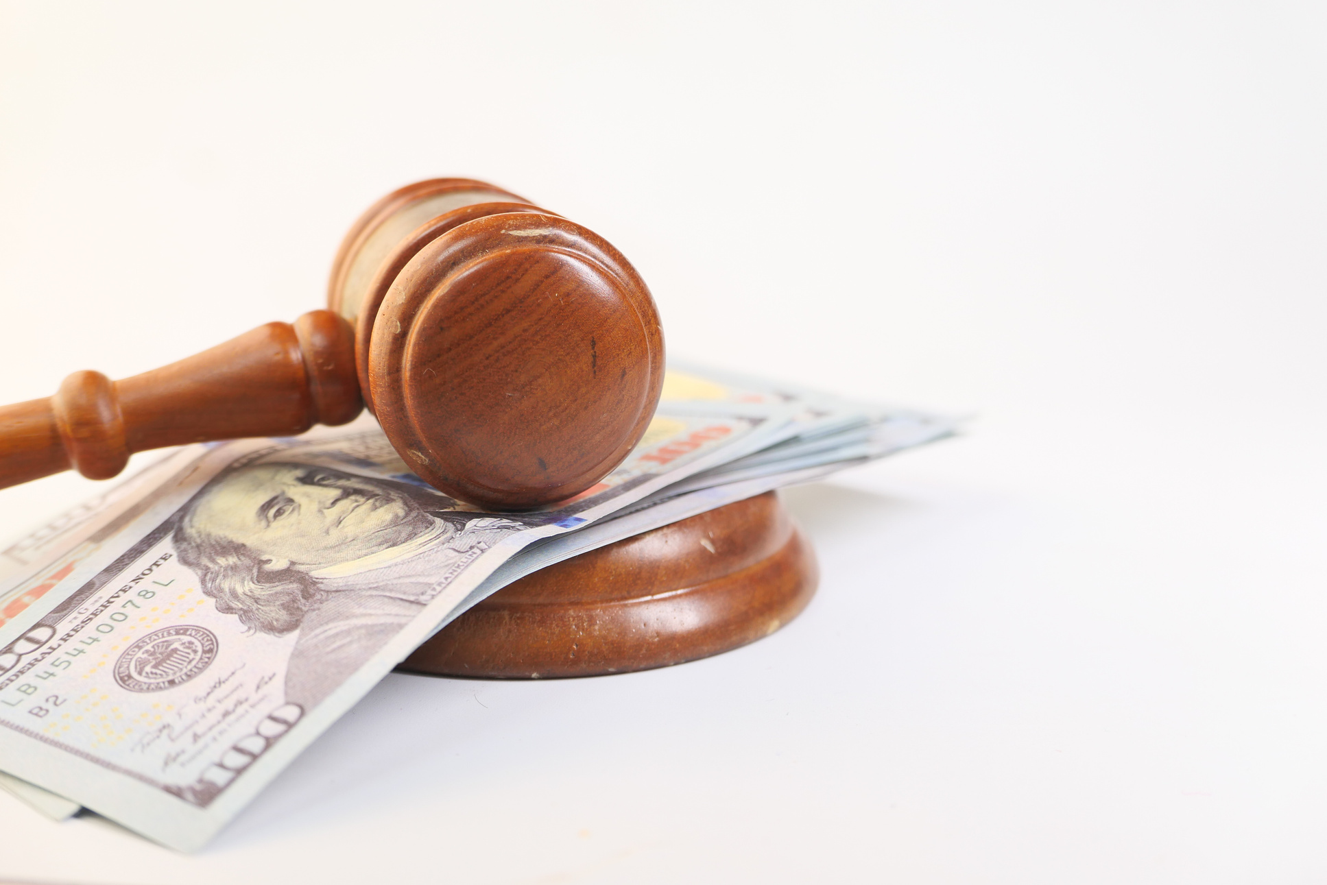 Close up of Gavel and Cash on White Background